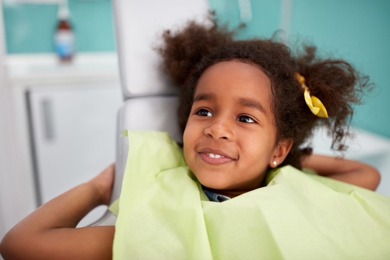 Young girl smiling in dental chair during appointment children's oral health dentist in Chester Springs Pennsylvania